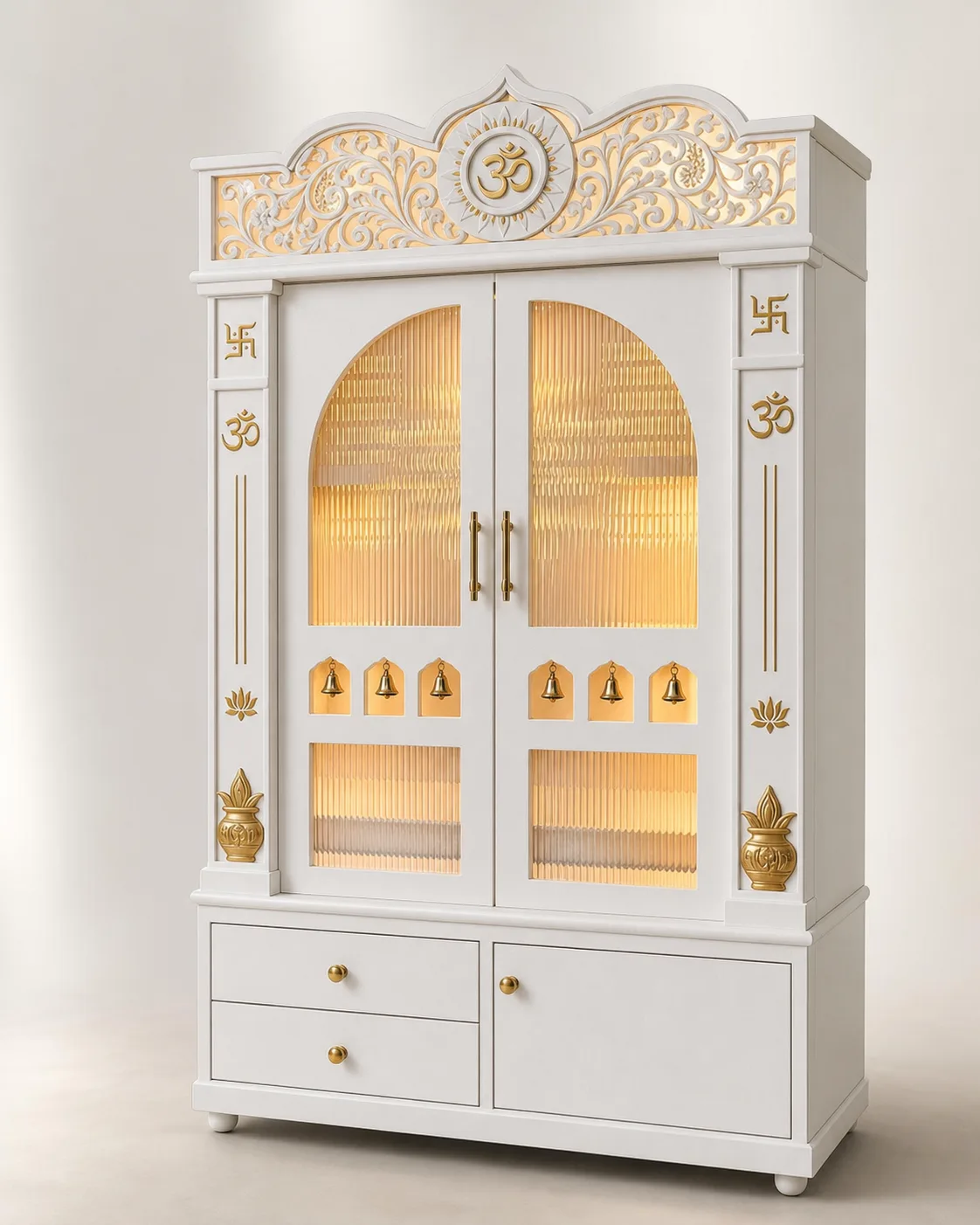 Ornate white mandir with a gold Om carved pediment and two arched glass doors.