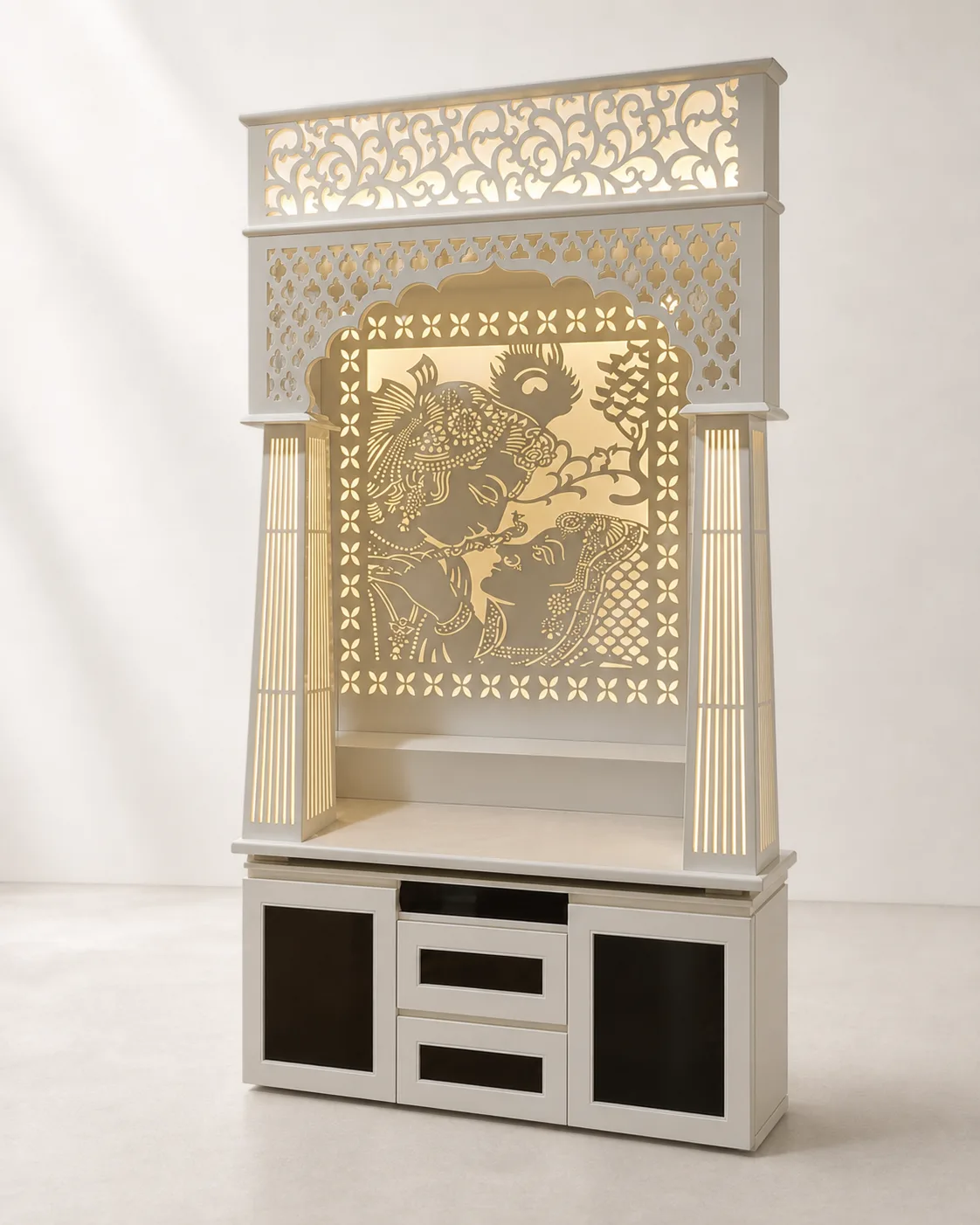 Mandir unit with square backlit Radha-Krishna jaali panel, reeded pillars and fretwork crown.