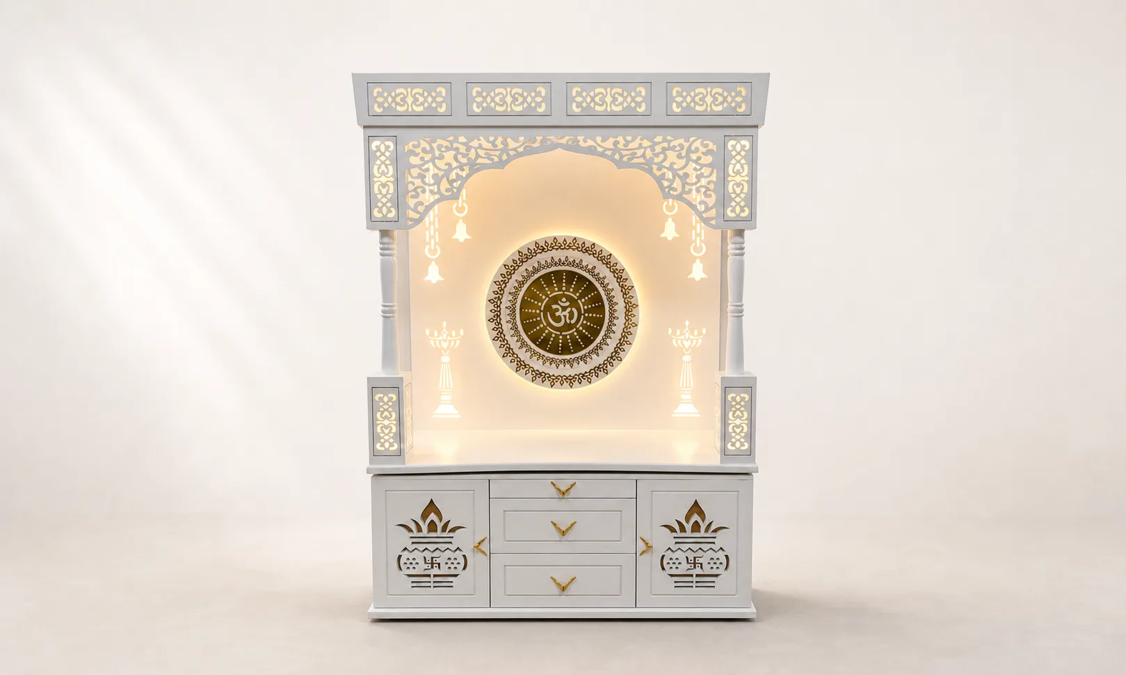 Mandir unit with a round Om mandala medallion, kalash and bell motifs and lotus-carved drawer fronts.