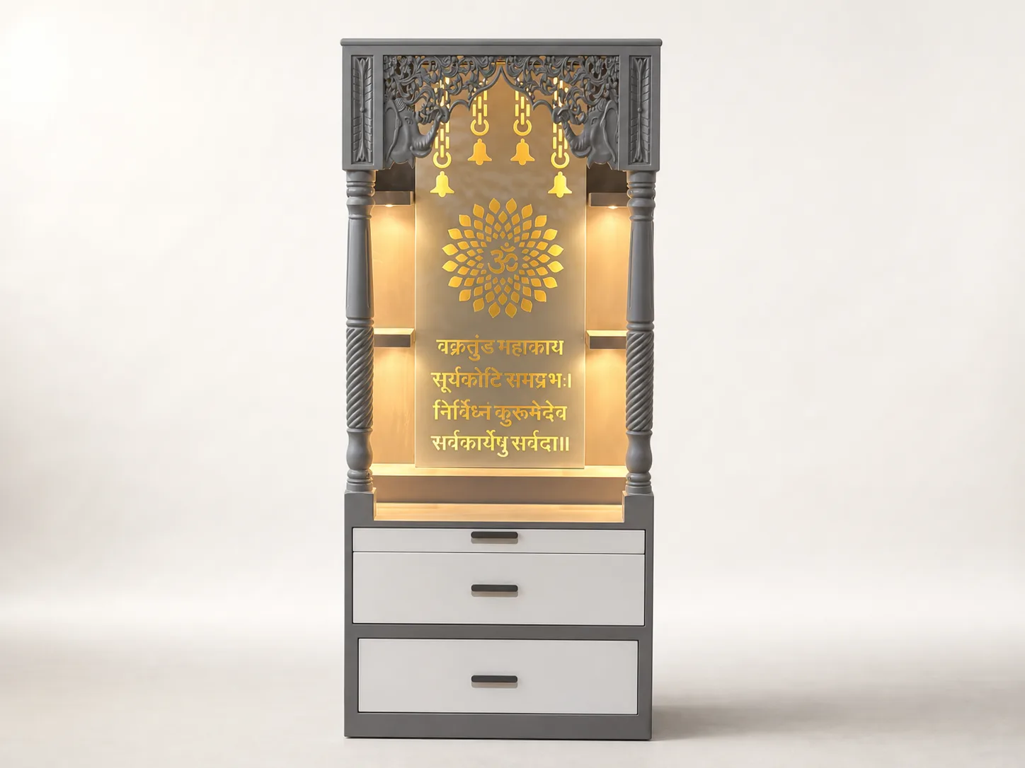 Grey framed mandir unit with carved pillars, gold lotus Om medallion and backlit Vakratunda mantra panel.