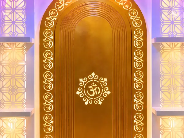 Close-up of the gold-amber arch niche and Om medallion