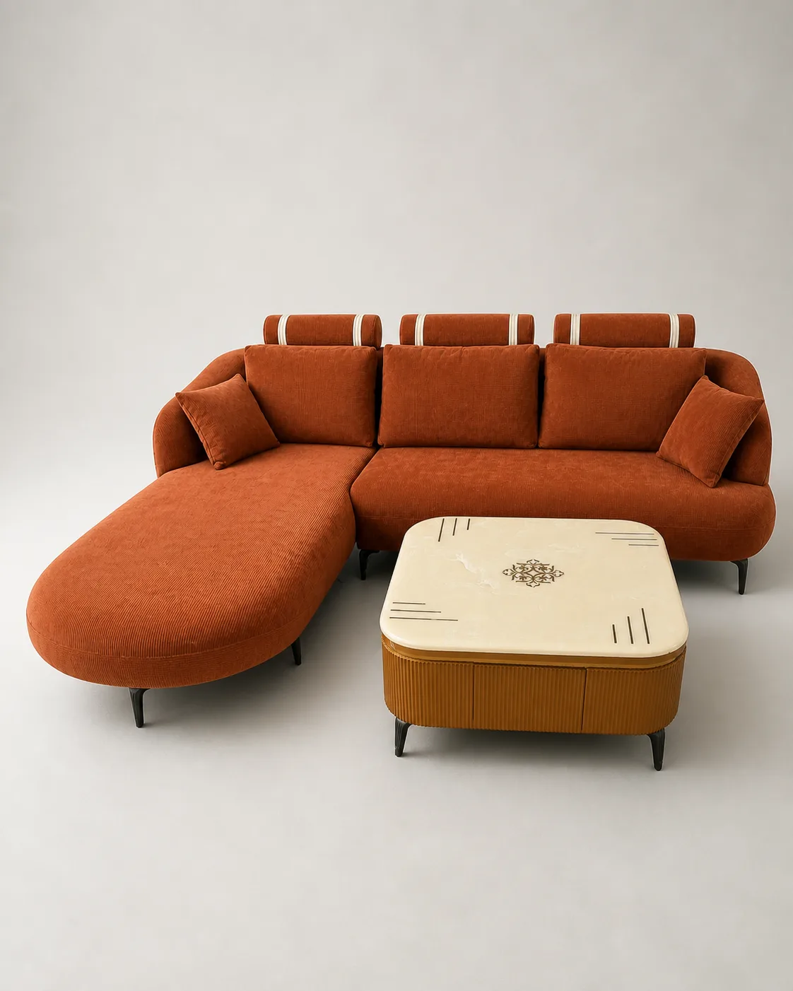 Rust terracotta corduroy L-shaped sofa styled with a marble coffee table.