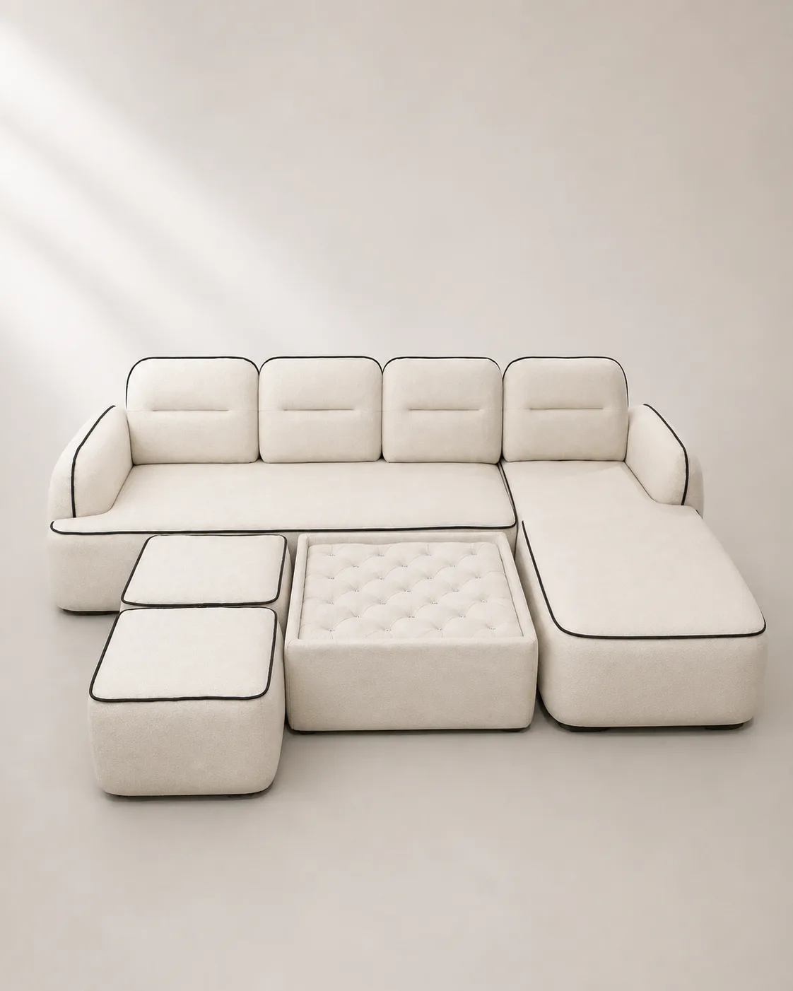 Off-white boucle sectional sofa with crystal-tufted ottoman.